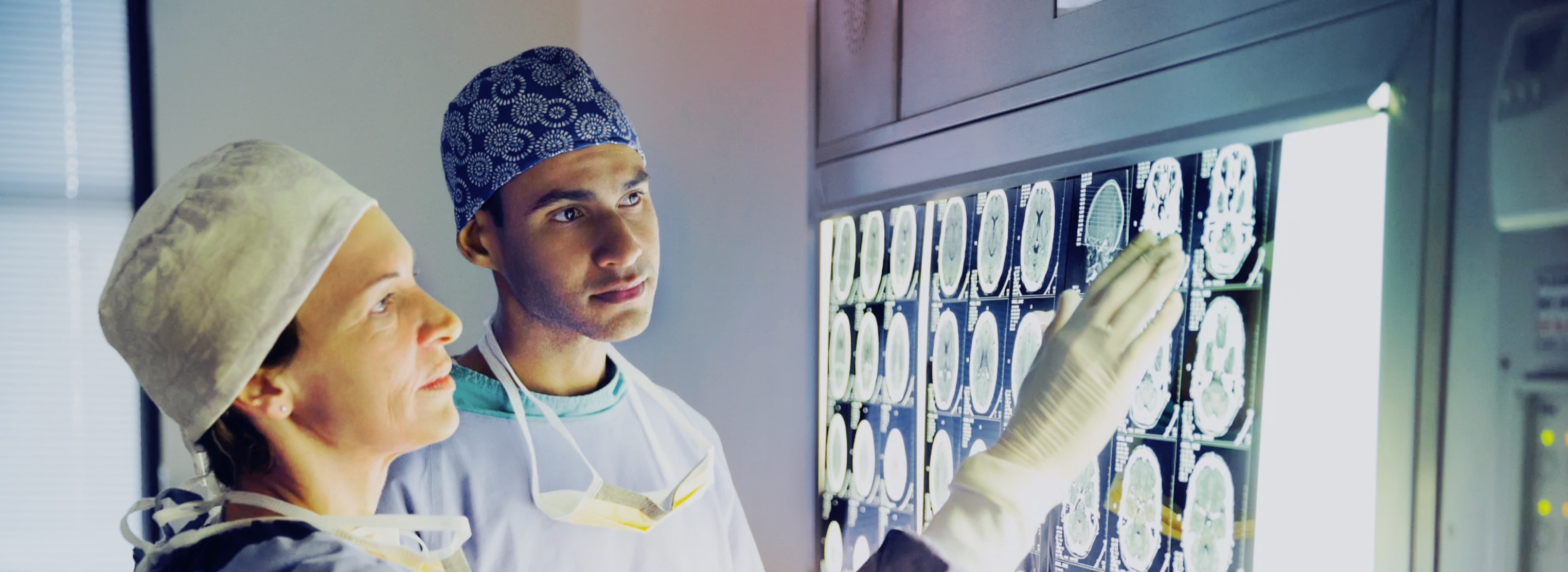 Two doctors analyzing CT scans of a human brain